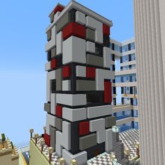 a very tall building sitting next to a tall building with red and white accents on it