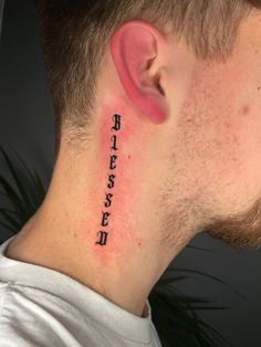 a man with a tattoo on his neck has the words written in chinese and english