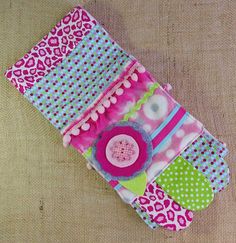 a cell phone case made out of fabric and buttons