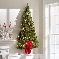 a decorated christmas tree in the corner of a room