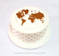 a cake decorated with the map of the world on it's side and gold dots