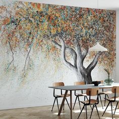 a dining room with a large tree painted on the wall