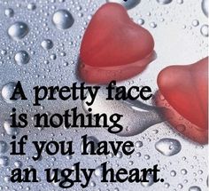 two red hearts sitting on top of a table with water droplets around them and the words, a pretty face is nothing if you have an ugly heart