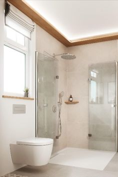 a bathroom with a shower, toilet and sink in it's center area next to a window