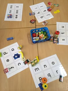 a wooden table topped with lots of cut out letters and diced fruits on top of it