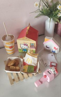 a table topped with donuts and other food items next to a cup of coffee