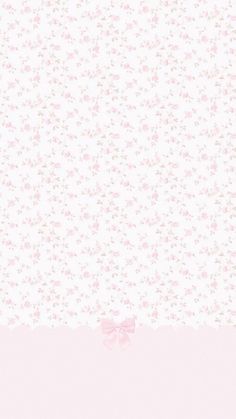 a pink and white floral wallpaper with a bow at the bottom in front of it