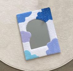 a blue and white mirror sitting on top of a table