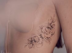 a close up of a woman's breast with flowers on it