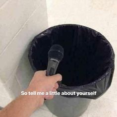 a person holding a microphone in front of a trash can with the words so tell me a little about yourself