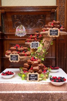 a table topped with lots of pastries and desserts