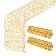 two rolls of gold foiled paper next to each other