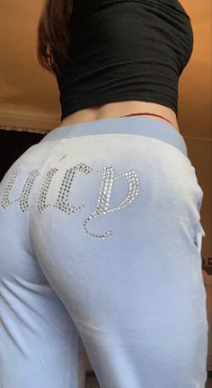 a woman in white pants with the word bling on her stomach and bottom half