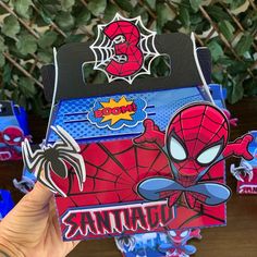 someone is holding up a spiderman party box