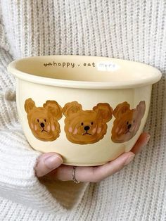 a person holding a bowl with bears on it