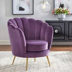 a purple chair sitting on top of a white rug