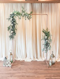 a wedding ceremony setup with white flowers and greenery