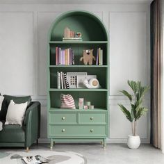 a living room with a green book shelf