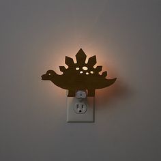 a light that is on the side of a wall with an electrical outlet in front of it