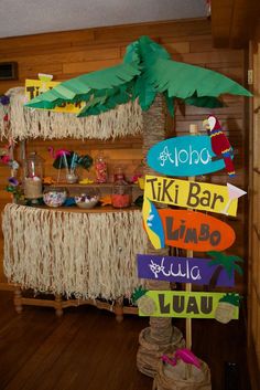 a tiki bar decorated with palm trees and signs