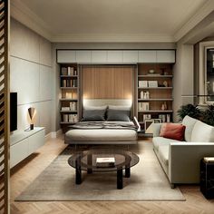 a living room with a bed, couch and coffee table in front of bookshelves