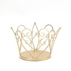 a gold metal crown sitting on top of a table