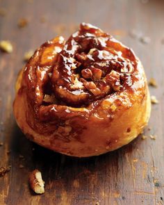 a cinnamon roll sitting on top of a wooden cutting board