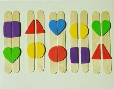 popsicles with different shapes and colors are arranged in the shape of hearts on sticks