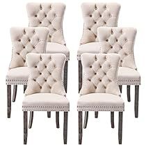 six white dining chairs with buttons on them