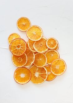 orange slices cut in half on a white surface