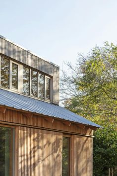 a small wooden building with lots of windows