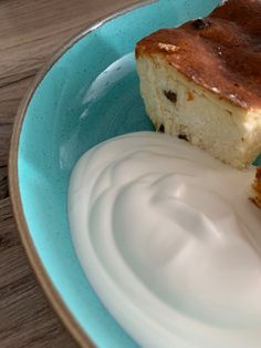 a piece of cake and yogurt on a blue plate