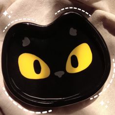 a black plate with yellow eyes on it