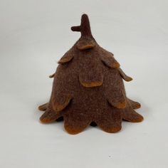 a brown felt christmas tree on a white background