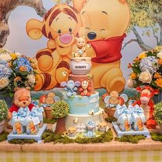 winnie the pooh and tigger birthday cake on display in front of wall mural