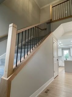 an empty living room with stairs leading up to the kitchen and breakfast nooks