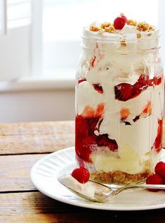 cherry cheesecake in a jar on a plate