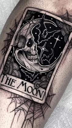 a tattoo with a skull and the moon on it