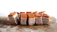 slices of meat sitting on top of a wooden cutting board