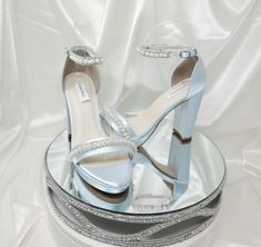 Blue satin Wedding Shoes with Sparkling Crystal and Pearl Trim Design are available in over 100 colors!  Sparkle with each step you take.  These beautiful shoes have a chunky heel and front platform.  These shoes are available in over 100 different colors including ivory, eggplant, David's Bridal Colors, as well as the option of sending us a sample swatch to color match for you!  The listing color picture has been dyed Baby Blue. The beautiful shoes have an approximate 4 1/8th inch block heel with a platform in the front of the shoe which is approximately 3/8th of an inch. * All dyed shoes can bleed when exposed to moisture. If you would like to protect your shoes please consider purchasing my water repellent service. You can chose this option from the above drop down menu when you are pic Blue Heels With Pearls, Light Blue Quince Shoes, Light Blue Heels Wedding, Blue Wedding Heels, Light Blue High Heels, Platform Bridal Shoes, Platform Wedding Shoes, Bridal Colors, Wedding Shoes Blue