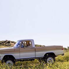 an old pickup truck parked in a field