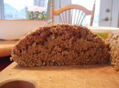 a loaf of bread sitting on top of a wooden cutting board