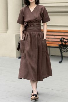 This elegant linen dress exudes a timeless charm with its deep brown hue and minimalist design. The dress falls to a mid-calf length, offering a flowy and comfortable fit that moves with ease. Ideal for both casual outings and more formal events.  DETAIL * 100% Linen * Two side big pockets * V neck dress * Short sleeve linen dress * Plus size dress * Fabric belted Linen dress * Midi length * Perfect for summer, spring * Casual linen dress, plus size linen dress * Wash by hand or machine with col Not Perfect Linen Dress, Casual Brown Linen Summer Dress, Casual Brown Linen Midi Dress, Summer Brown Linen Daywear Dress, Elegant Brown Linen Dress, Fall Linen Midi Dress With V-neck, Brown Linen Dress, Plus Size Linen Dress, Pear Shaped Dresses