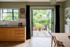 an open kitchen and dining area with sliding glass doors