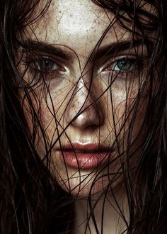 a woman with wet hair on her face