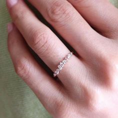 a woman's hand with a diamond ring on it