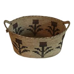 a woven basket with brown and black designs on it