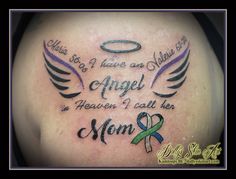 the back of a woman's shoulder with an angel and mom tattoo on it