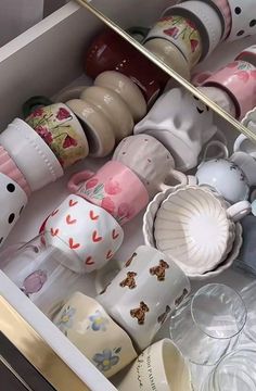 a drawer filled with cups and saucers