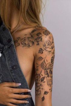 a woman with tattoos on her arm and shoulder